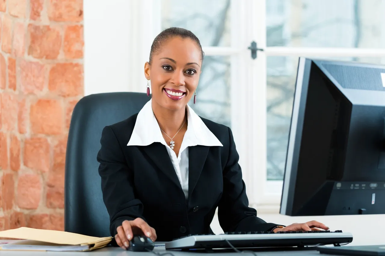 Smiling office worker at her desk