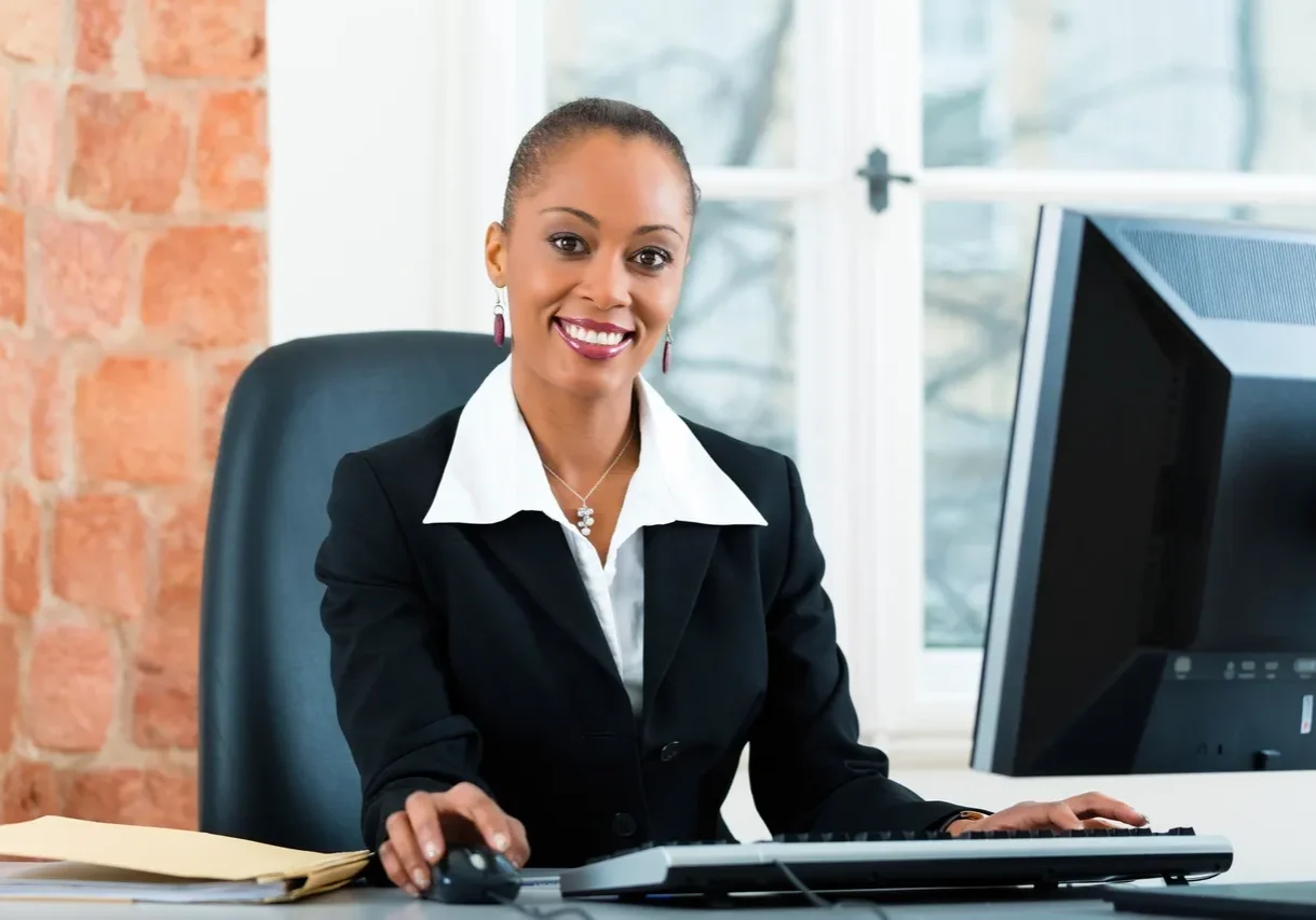 Smiling office worker at her desk